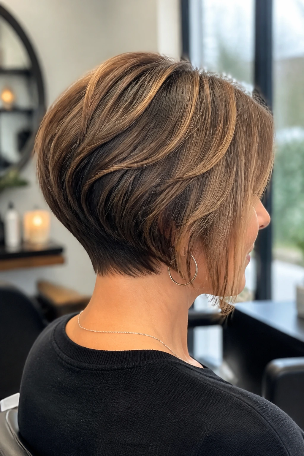 Close-up of a real woman with an angled stacked bob showing crown layers
