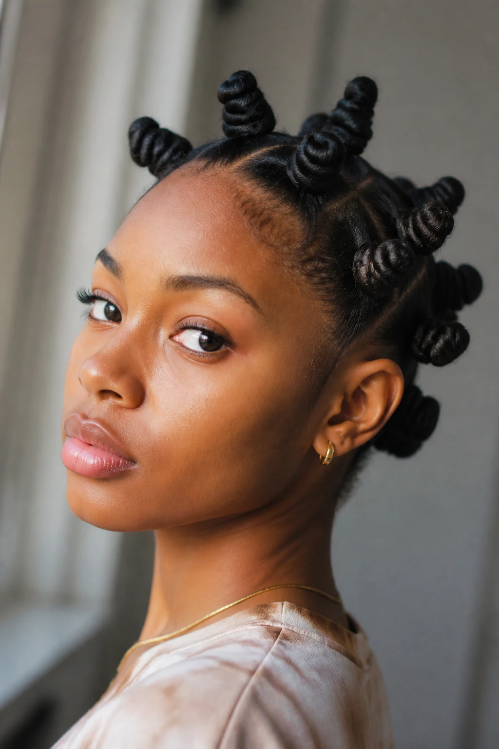 Close-up of a real person with several tiny Bantu knots on the crown