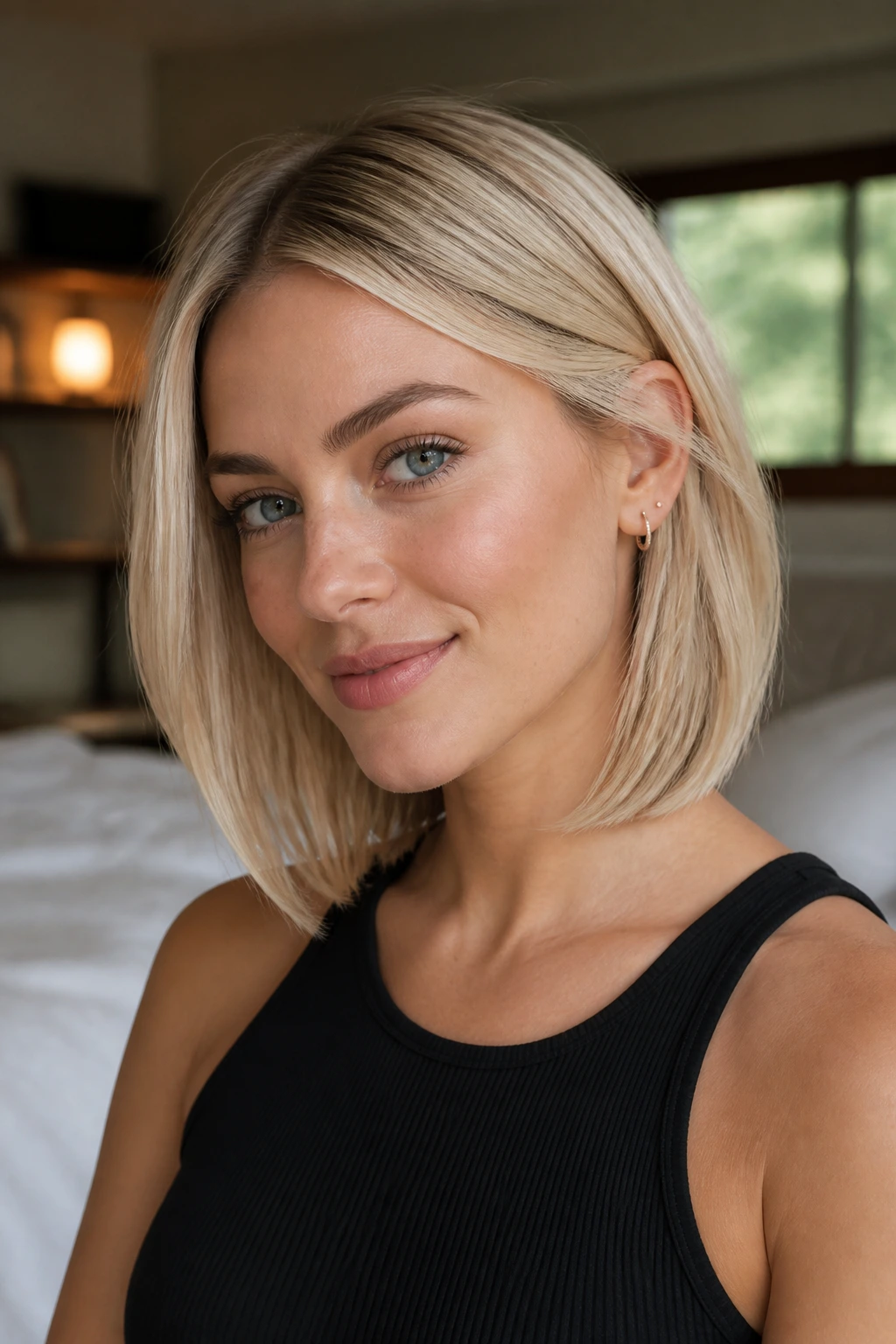 Close-up of a real woman with a soft-tapered baby-blonde long bob in natural light