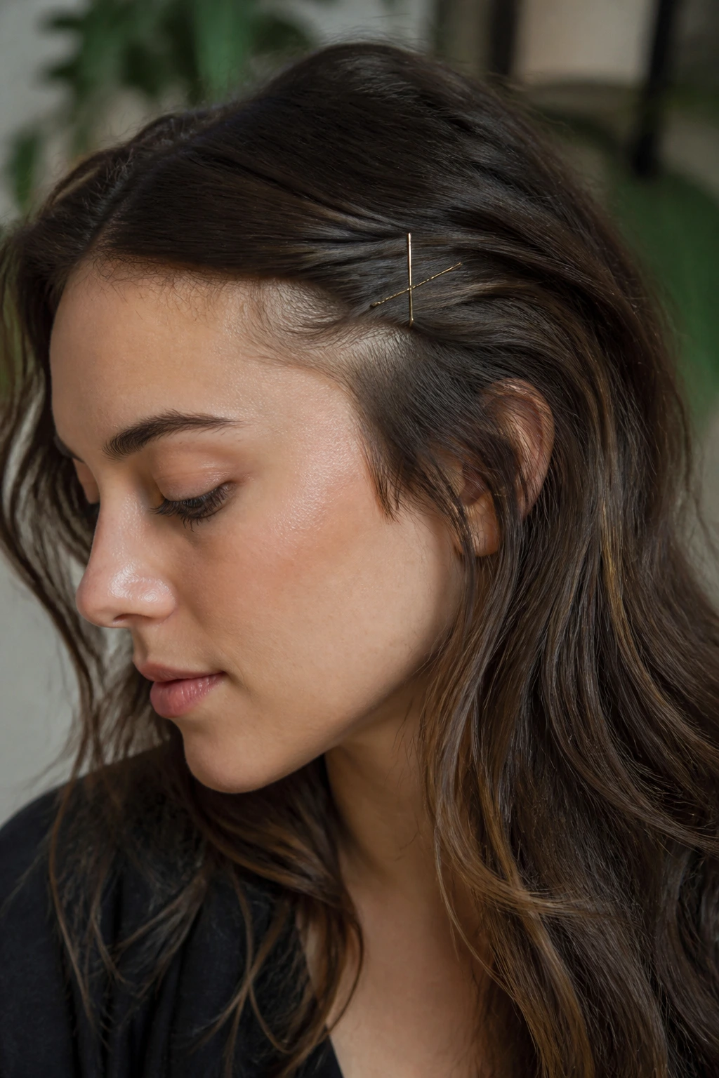 Close-up of a woman with hidden bangs tucked under hair pinned by crossed bobby pins