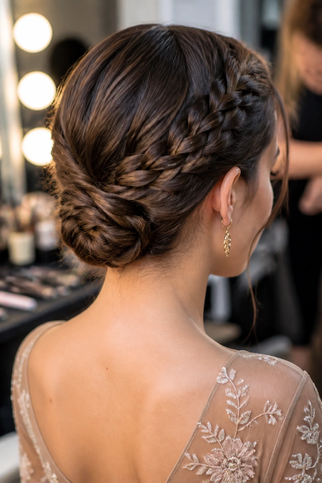 Rear/side close-up of a real woman with a braided chignon for short hair