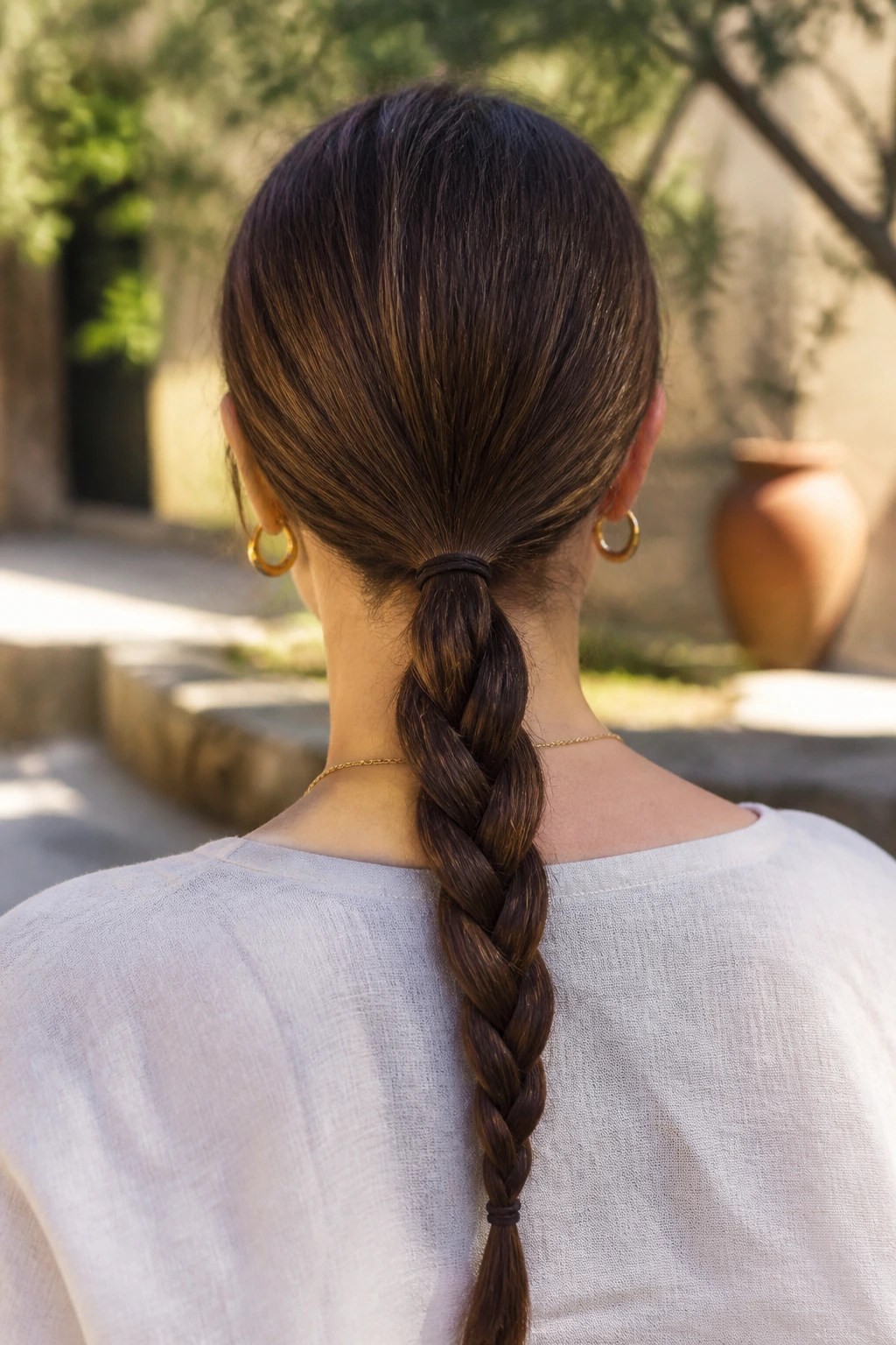 Back of head showing a low braided ponytail on a real person