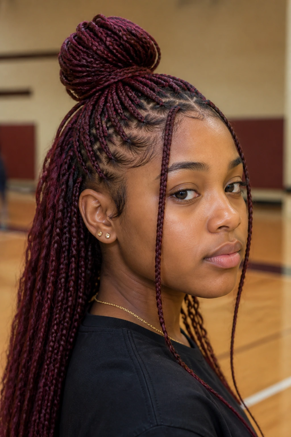 Student with burgundy half-up half-down top knot.