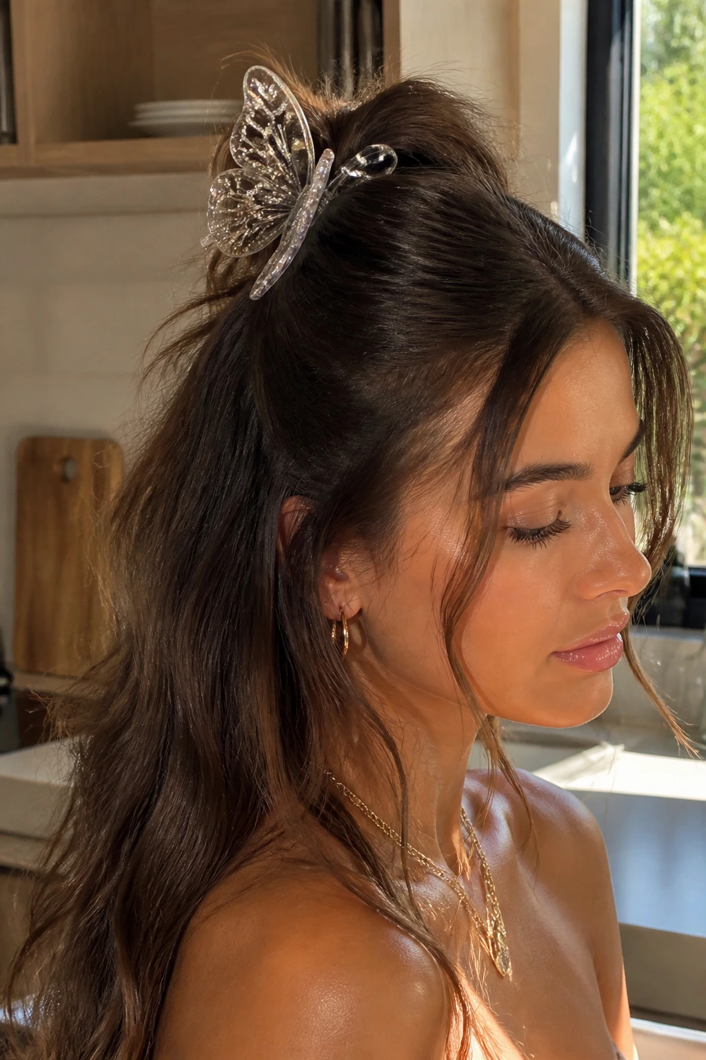 Real woman wearing a half-up hairstyle secured with a large butterfly clip.