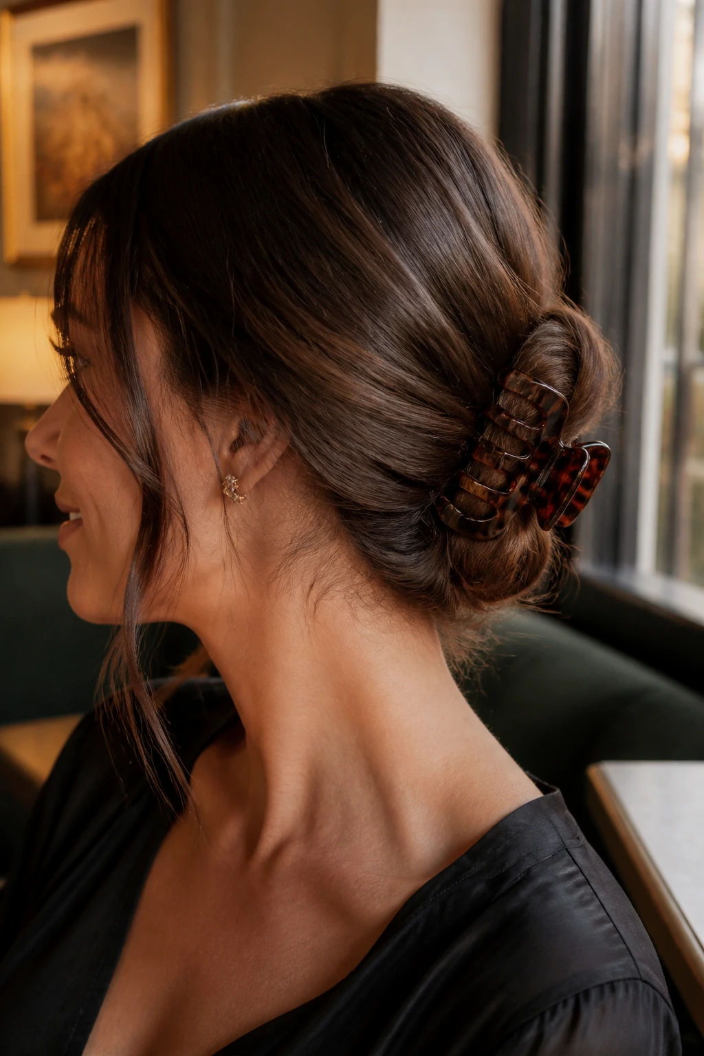 Close-up of a real woman with a claw-clip chignon at the nape