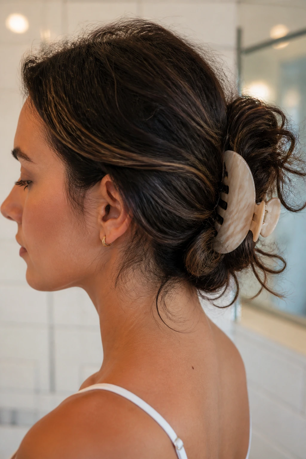 Close-up of a person with a low-slung twist secured by a claw clip