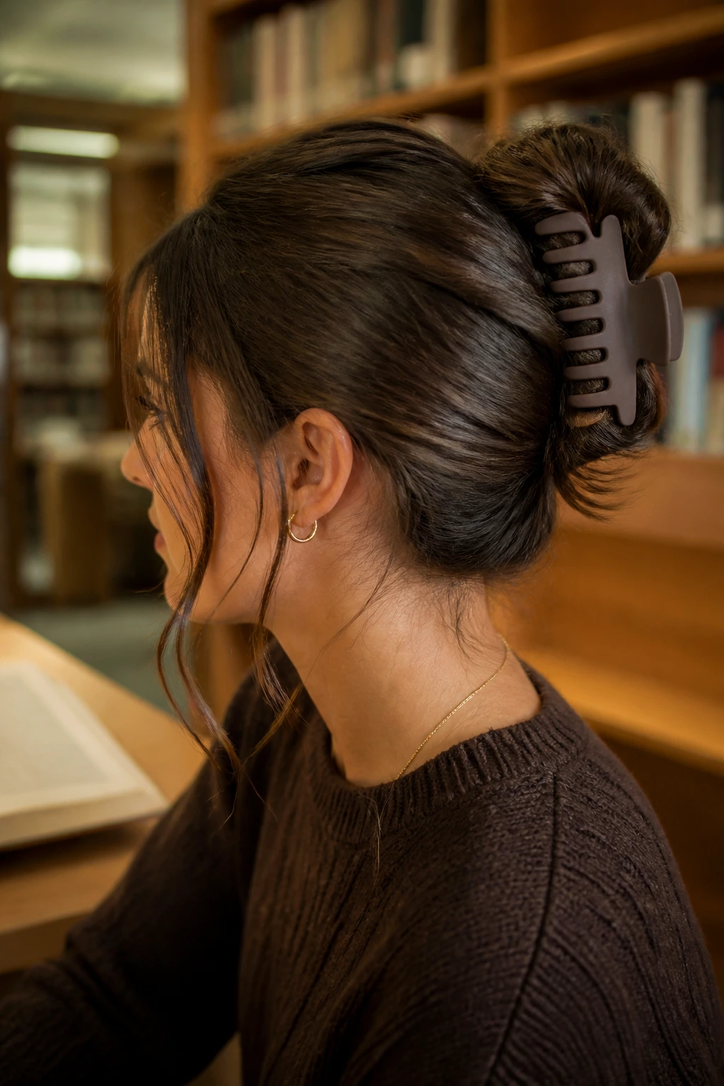 Profile of a real person with a claw clip tuck hairstyle