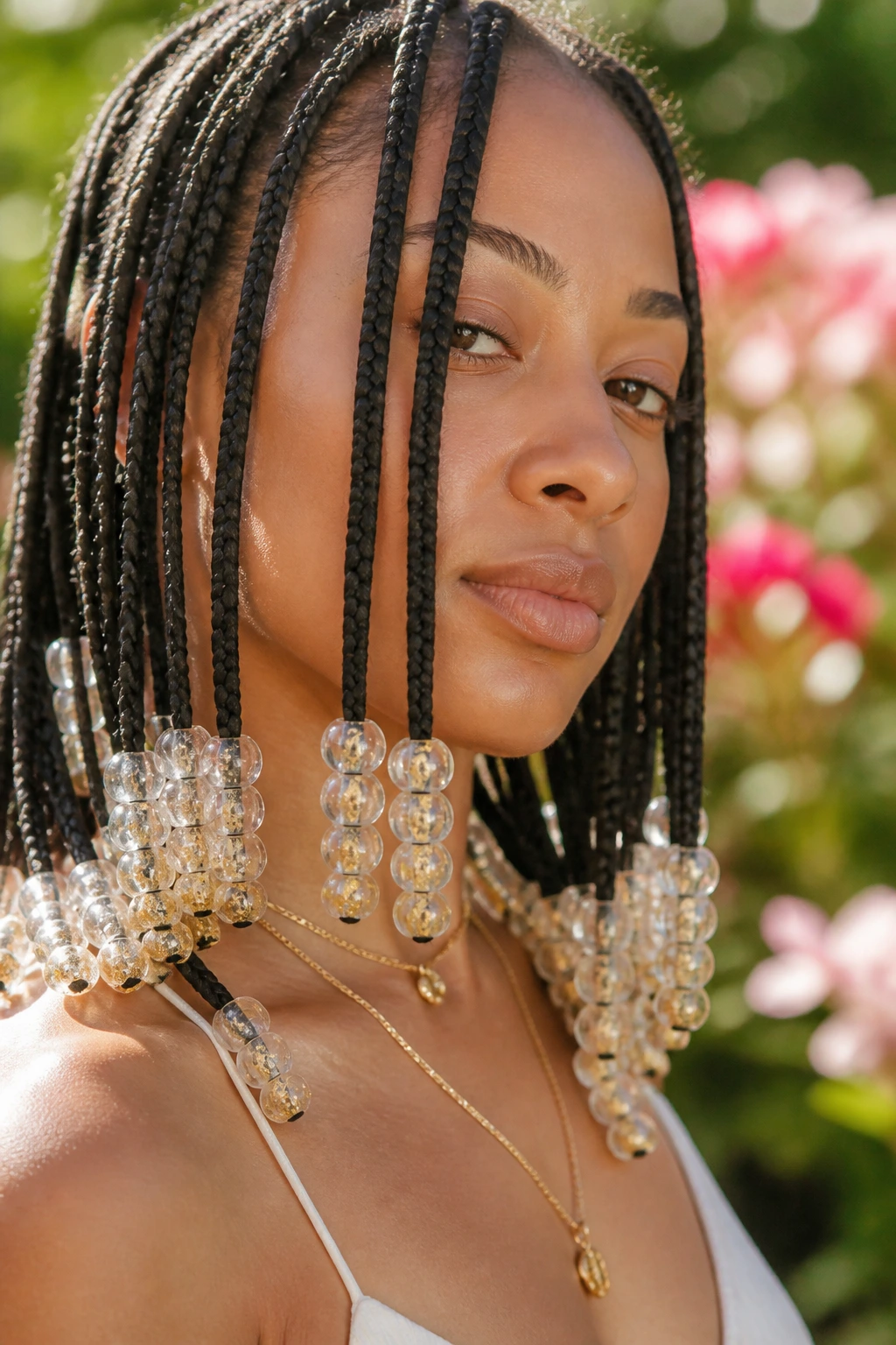 Close-up of clear beads with gold flecks on braids