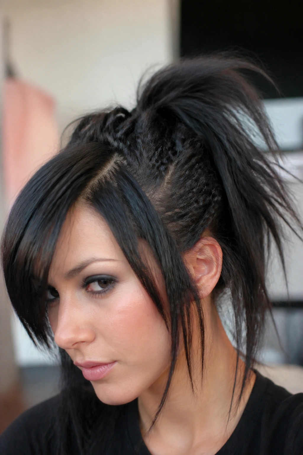 Close-up of crimped accents in a messy high ponytail on a real person