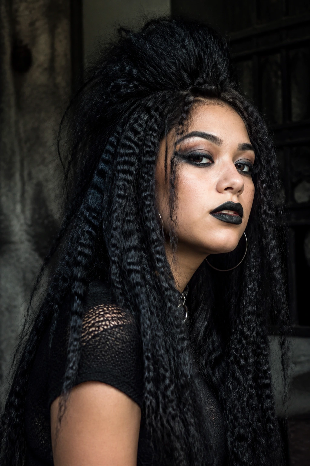 Latina woman with crimped gothic texture hair and dramatic volume