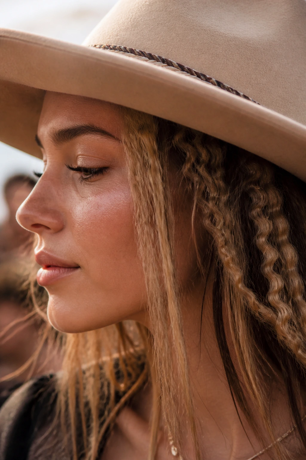 Real person with crimped sections peeking from under a wide-brim hat