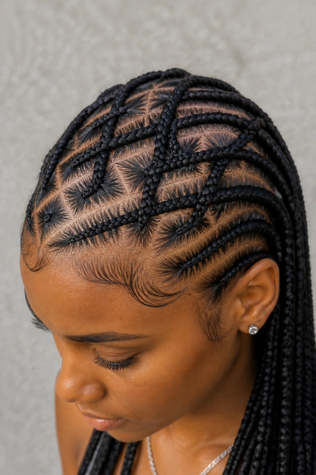 Close-up of criss-cross cornrows on a real woman in natural light