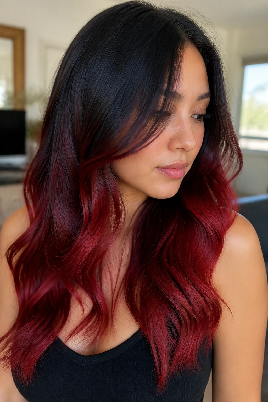 Close-up of deep cherry ombré with black roots and red ends on a real person.