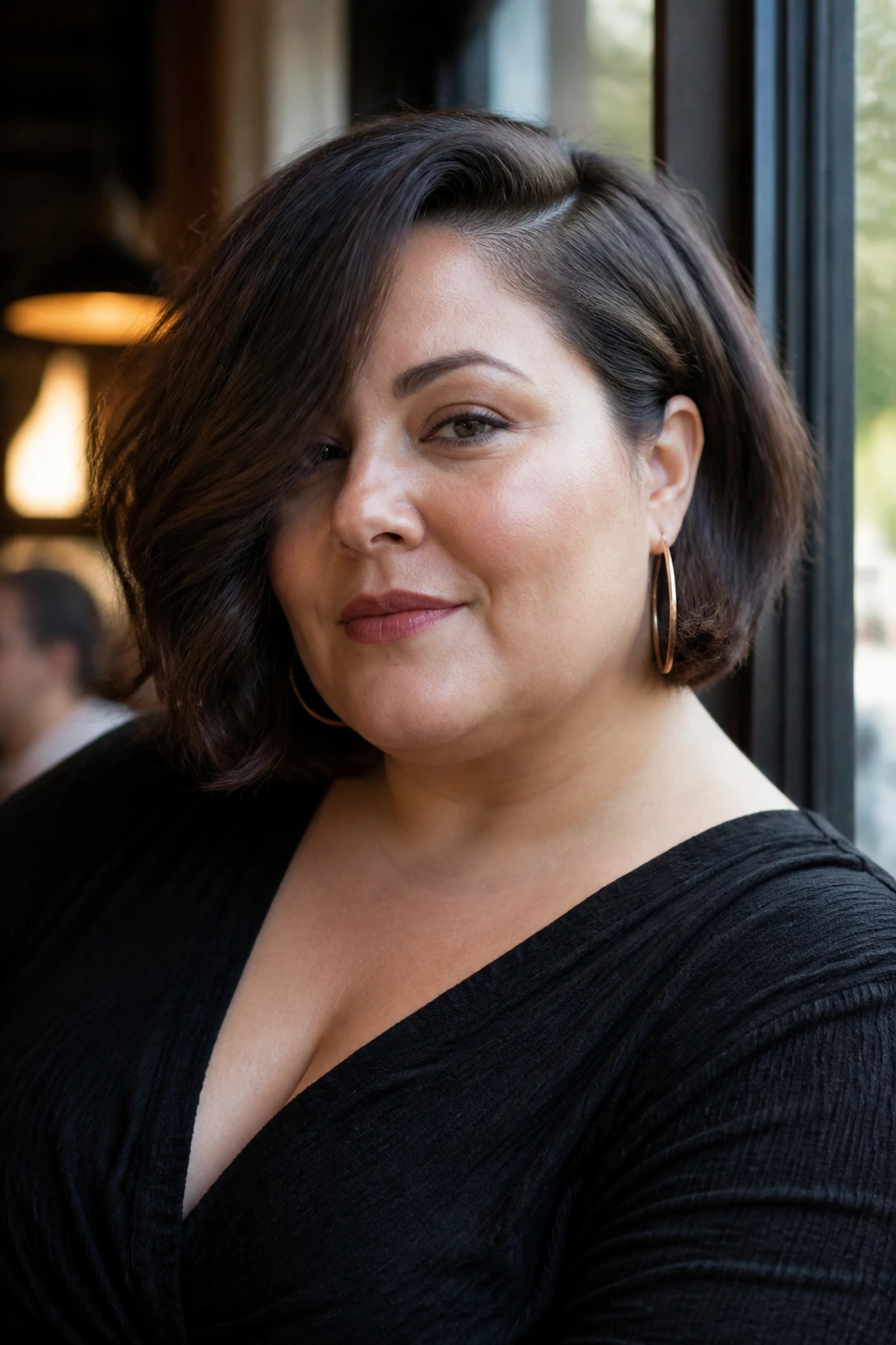 Portrait of a woman with a deep-parted side bob and cheekbone-length bangs