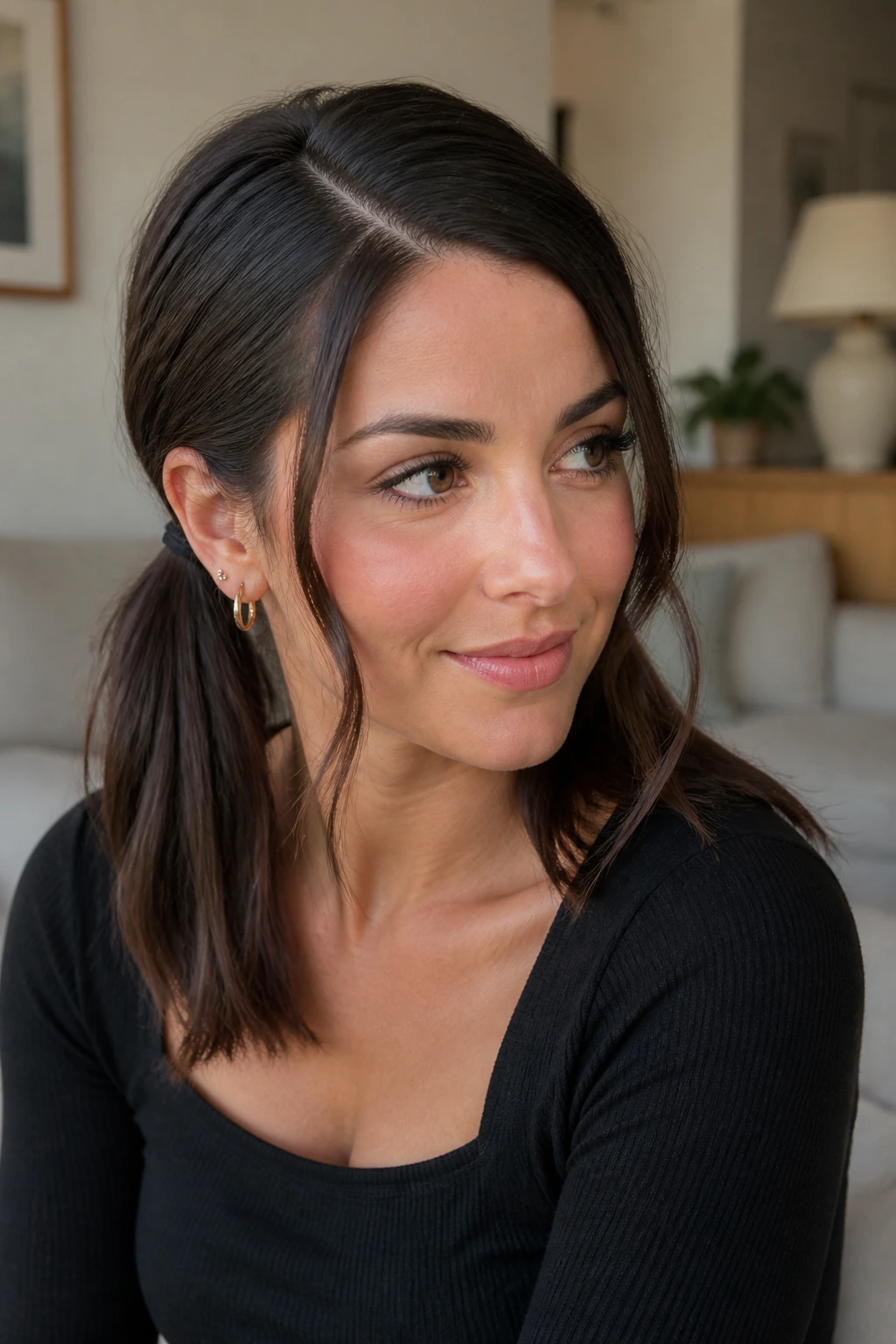 Deep side part with face-framing tendrils and pigtails.
