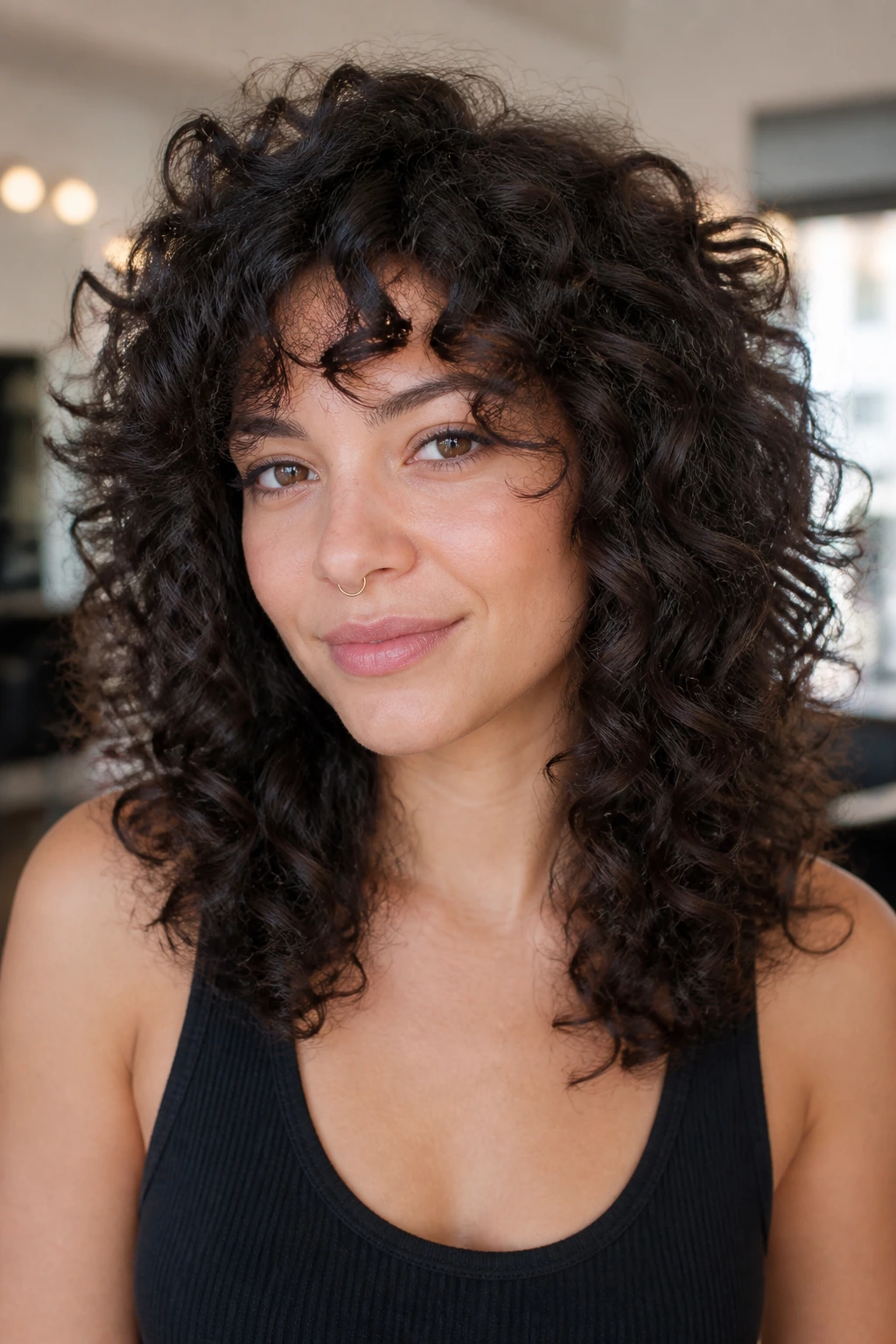 Close-up portrait of a real person with a Deva-cut inspired curly shape filling the frame
