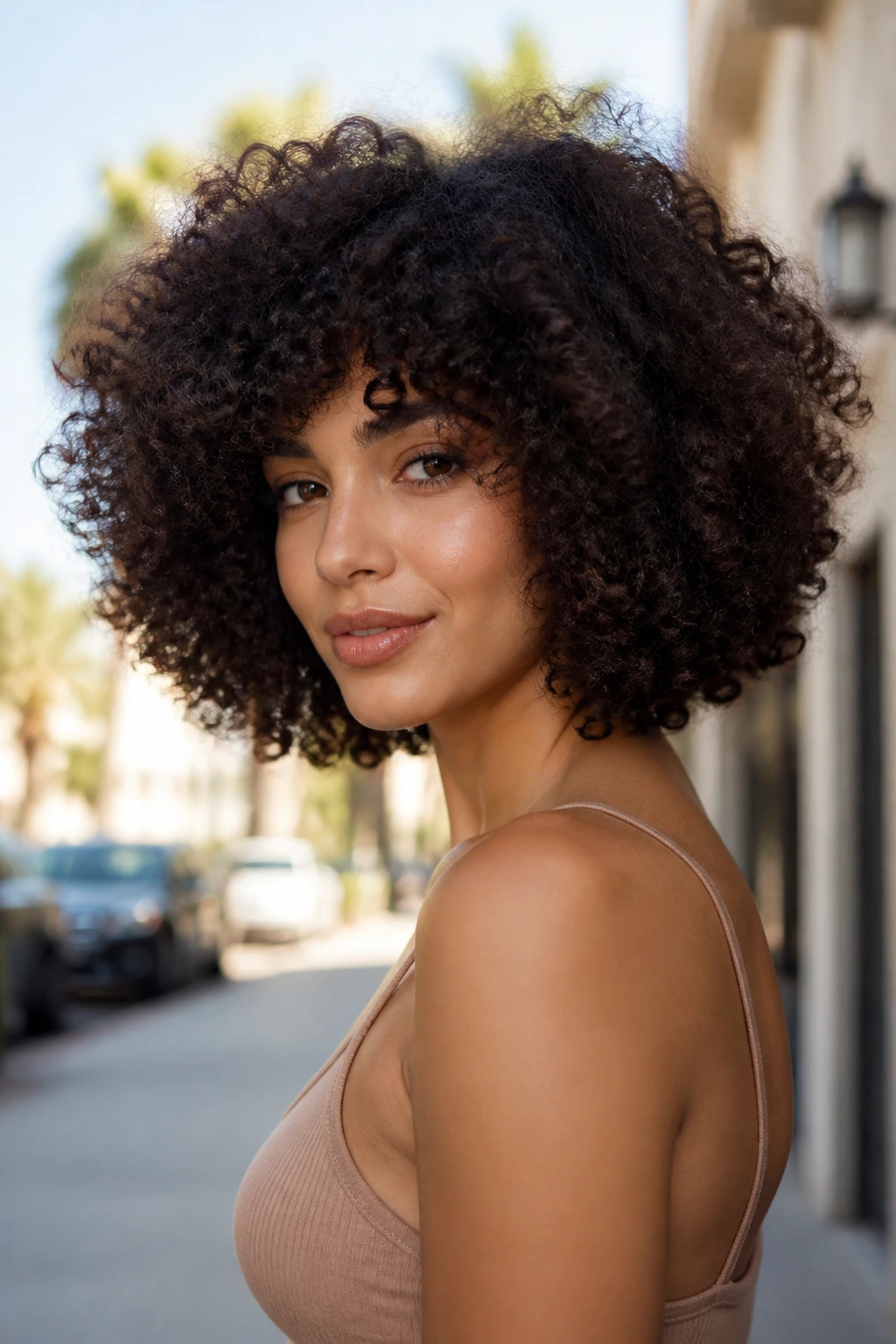 Three-quarter portrait of a real person with a diffused, voluminous afro-bob hairstyle