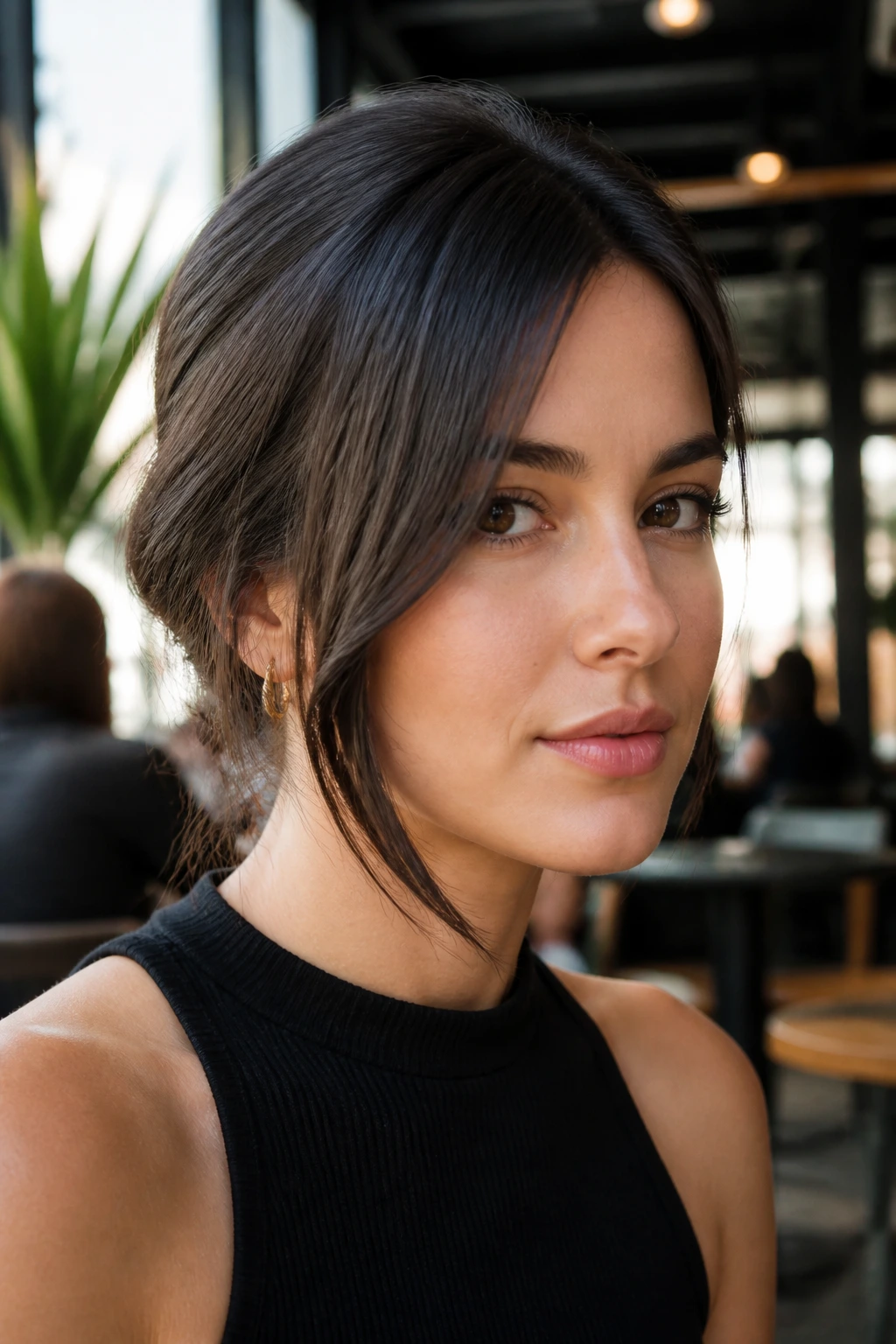 Close-up of woman with long disconnected side bangs framing one side of the jawline