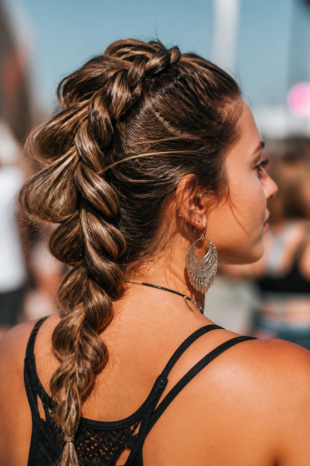 Close-up of a real person with dragon fins formed by a Dutch braid along the back