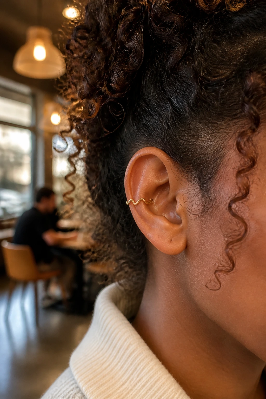 Close-up of wavy wire ear cuff on real person