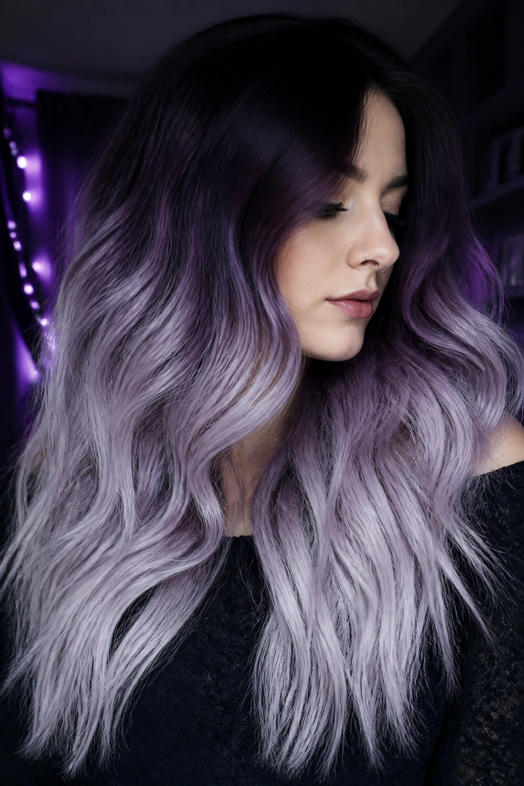 Close-up of thick hair transitioning from midnight violet roots to lilac frost ends