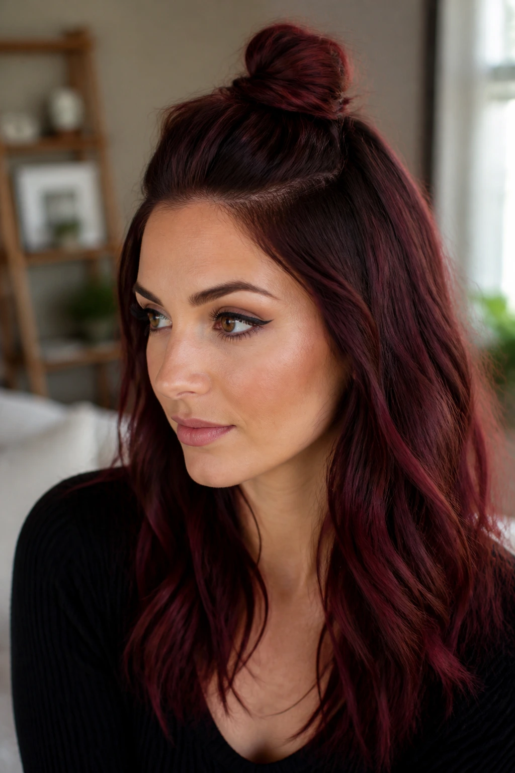 Real woman with half-up knot hairstyle in maroon hair.