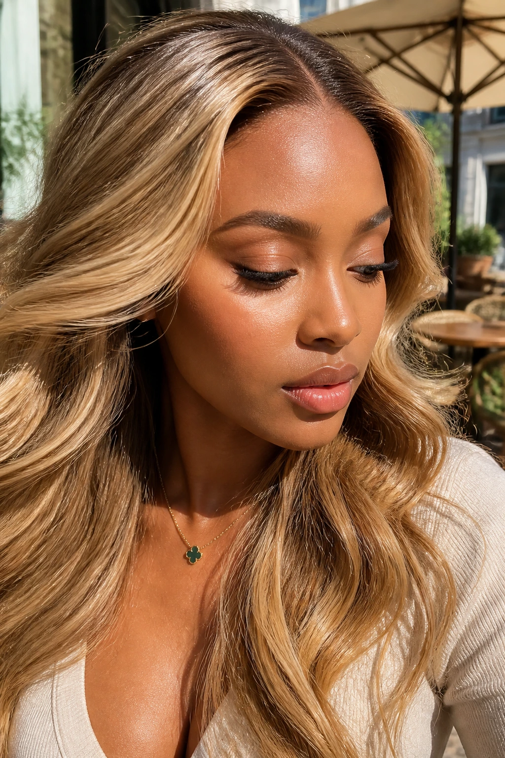 Close-up of a warm honey blonde HD lace front wig on a real person