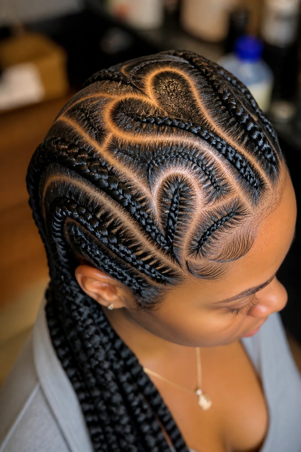 Real person with heart-shaped cornrow partings around the crown