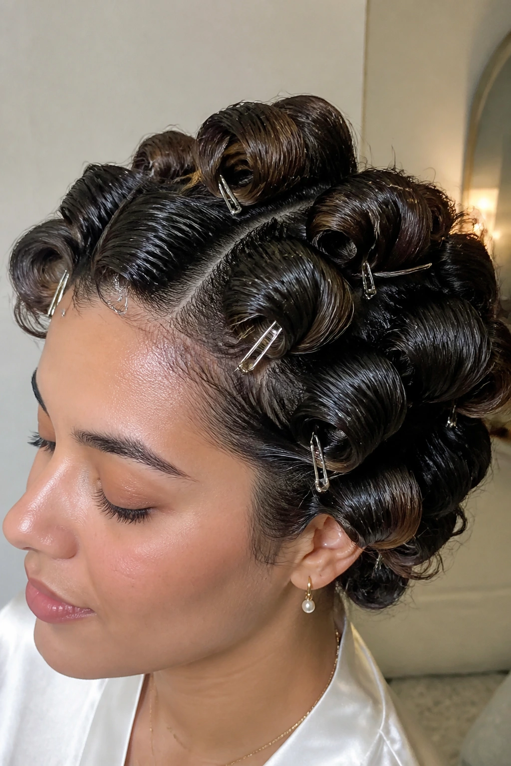 Close-up of pinned curls with serum sheen for humidity protection.