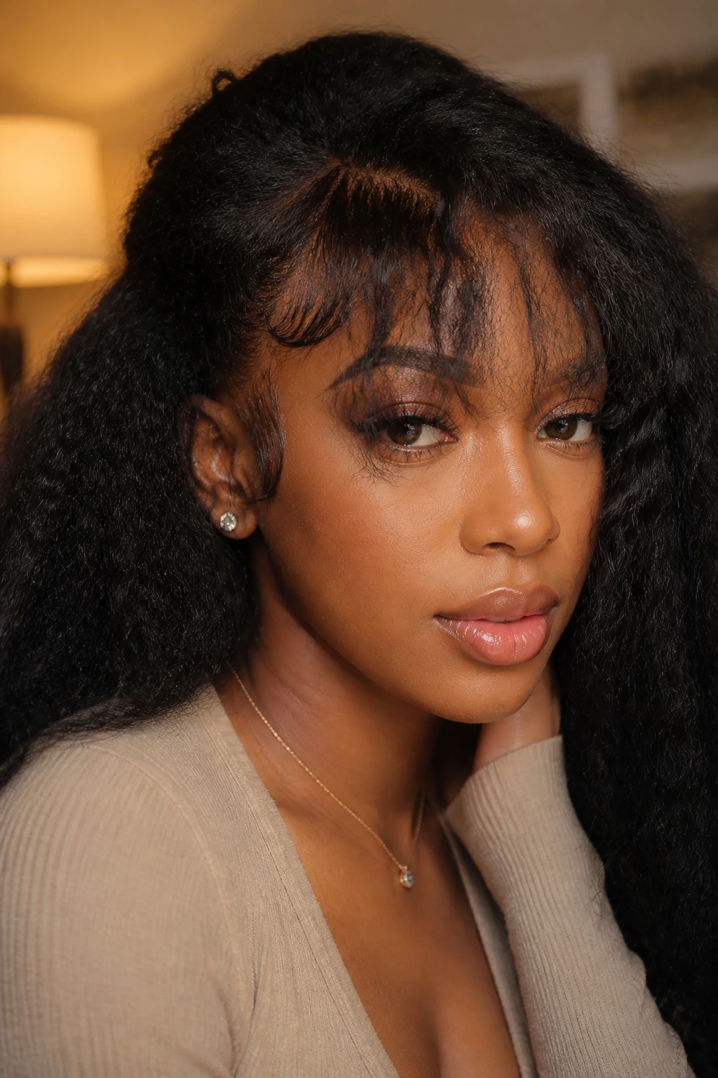 Close-up of a person wearing a kinky edge lace-front wig with piece-y bangs