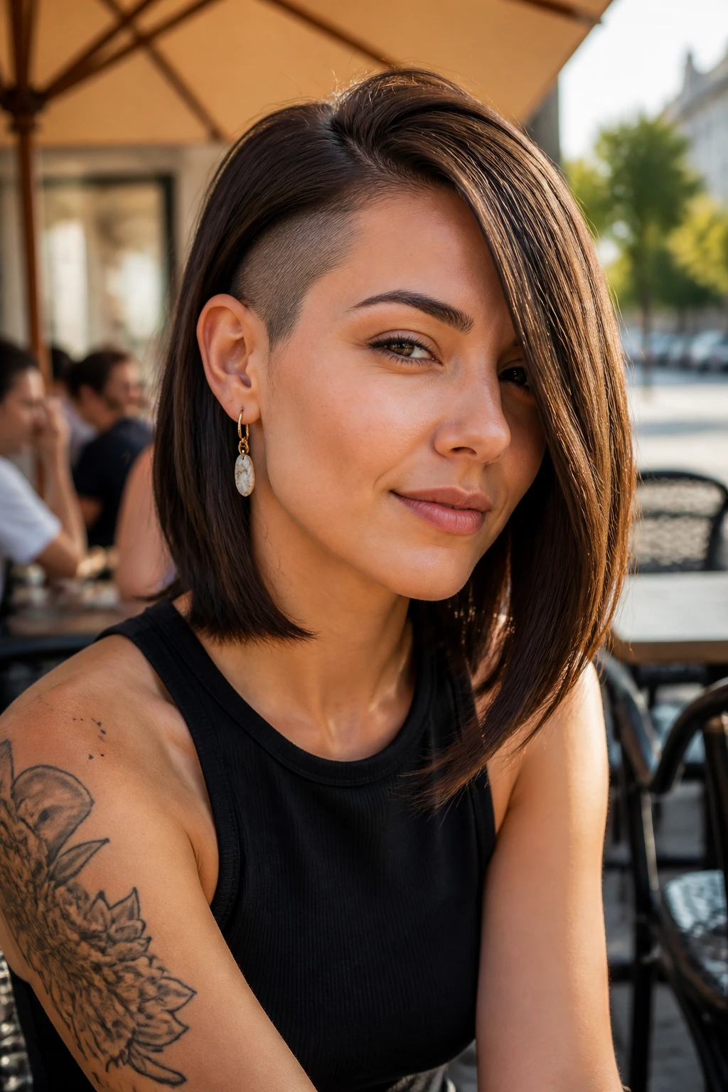 Portrait of a real person with a lob and side undercut at temple in street cafe setting.