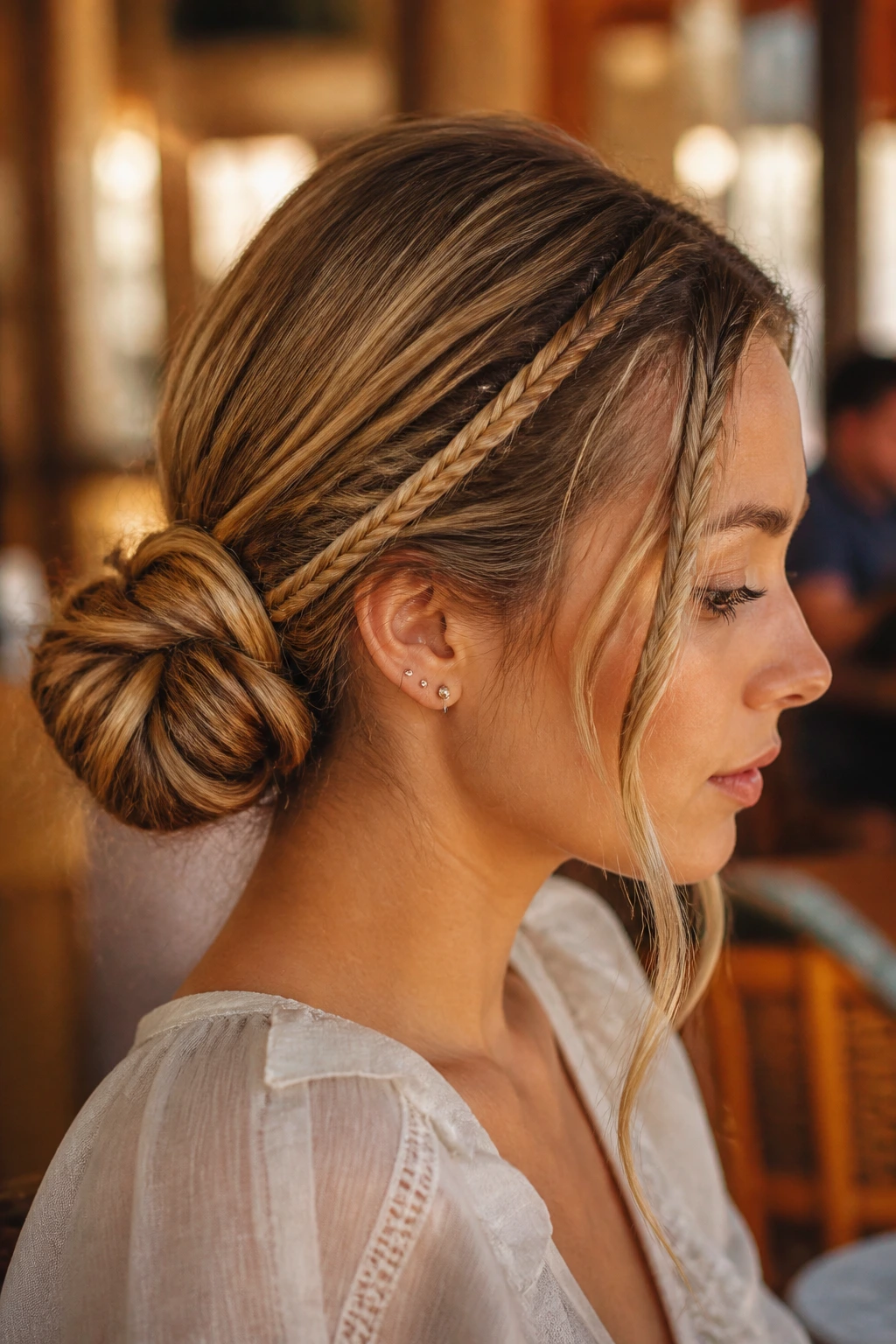 Close-up portrait of a woman with a low braided chignon