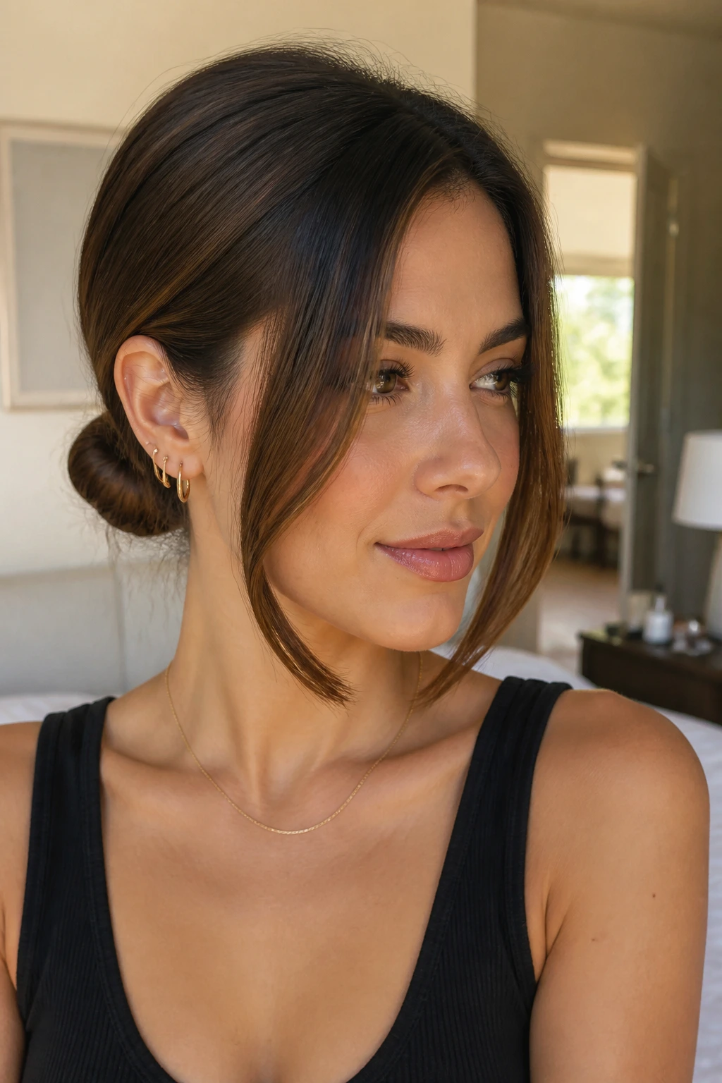 Real woman with a low chignon and face-framing pieces