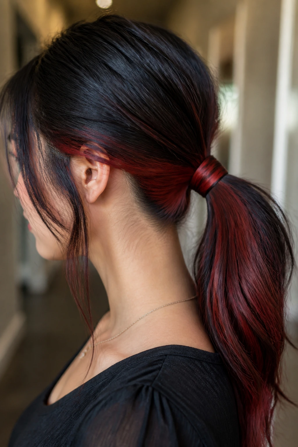 Close-up of a real person with a wrapped low ponytail hiding the elastic.