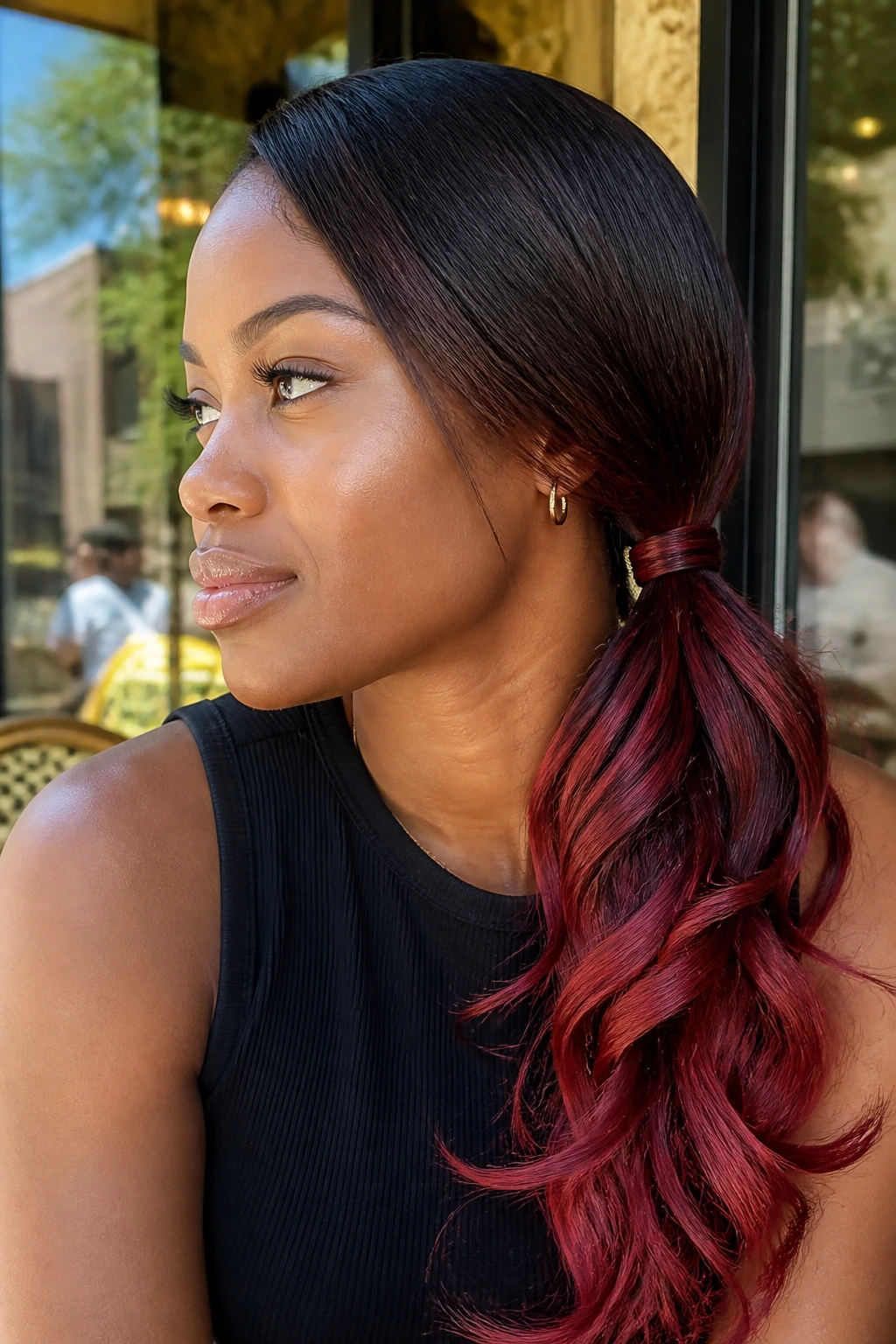 Real woman with a low side ponytail twisted detail and red tips