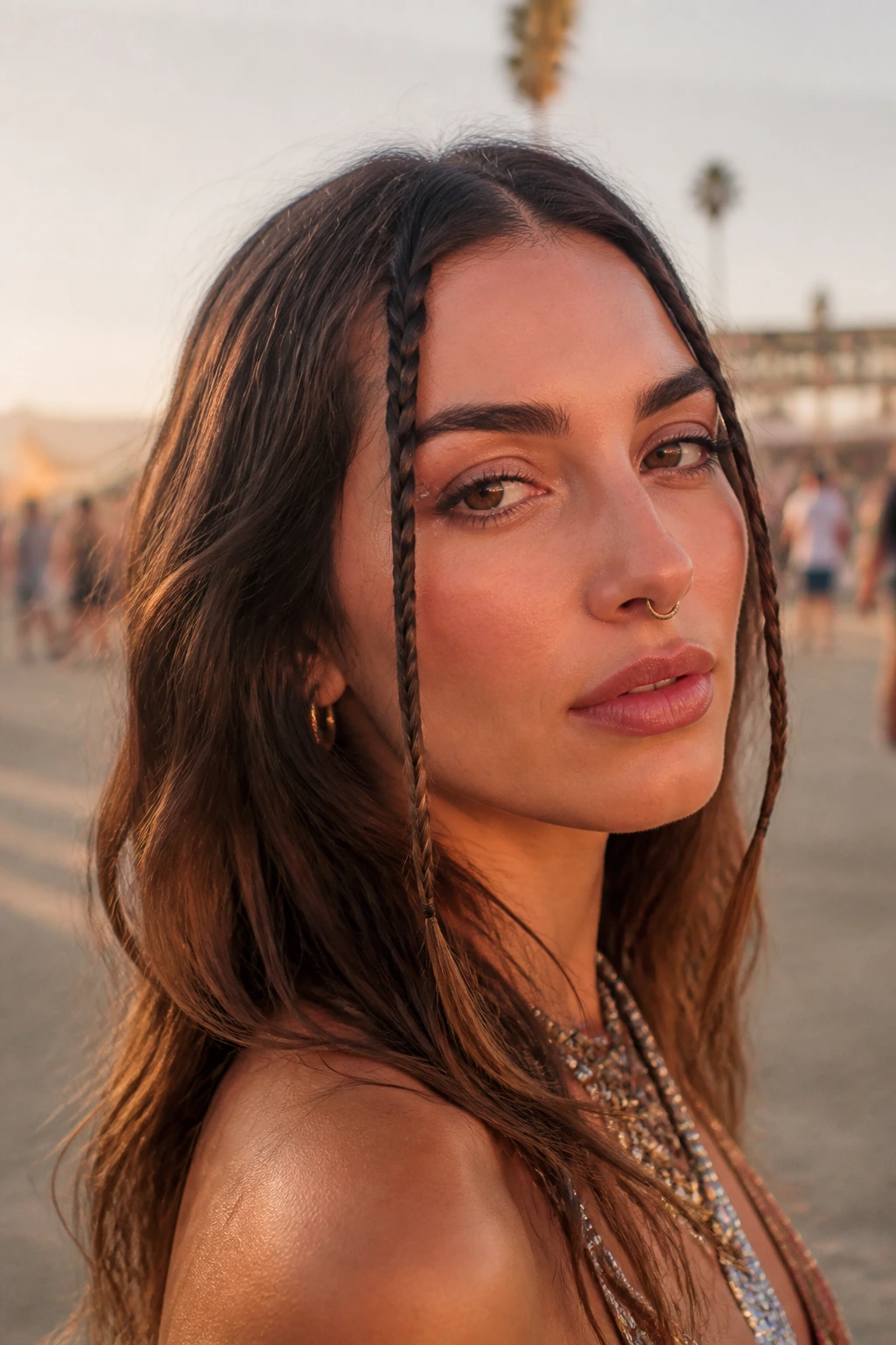 Close-up of micro braids framing the face at a desert festival.