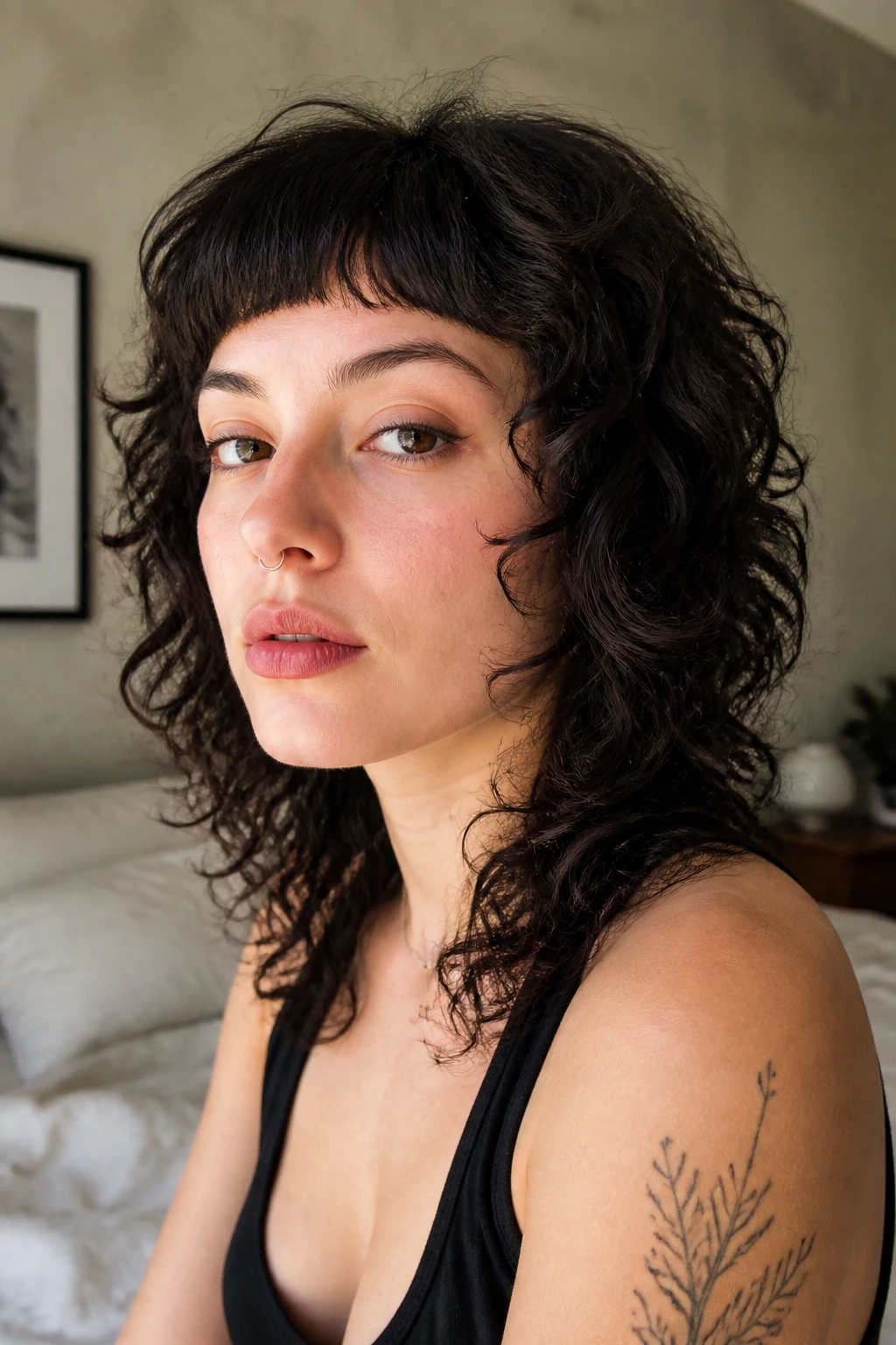 Close-up of a real person with a micro-fringe and shaggy layers, in soft daylight interior.