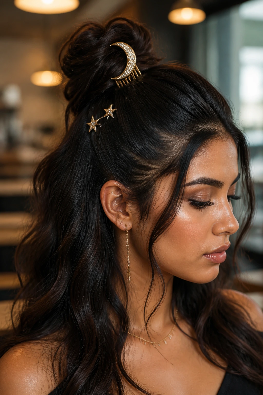 Close-up of a real woman with crescent comb above half-up bun in cafe light
