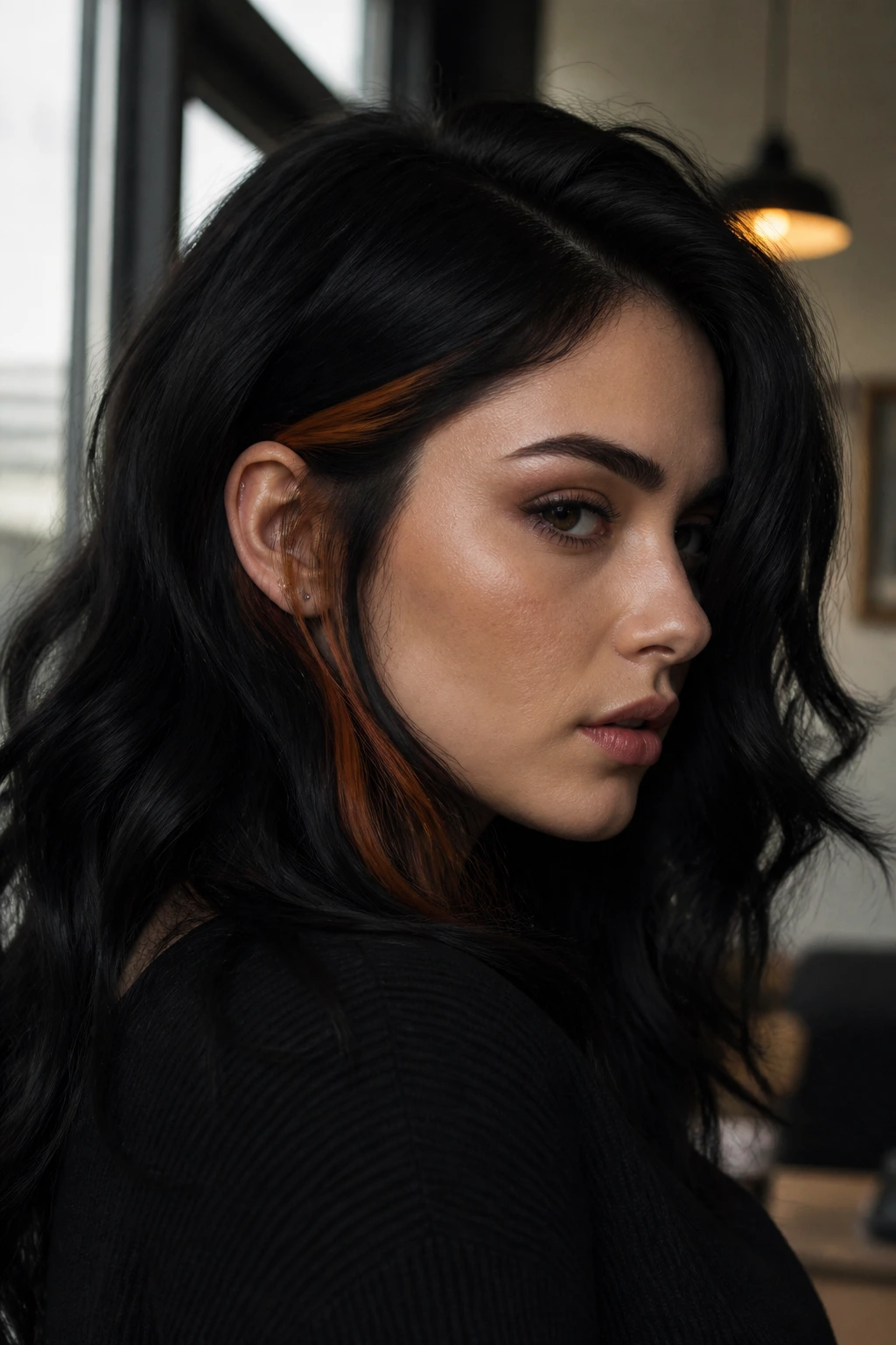 Close-up of black hair with a slim copper accent behind the ear