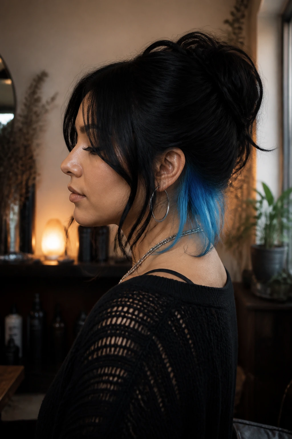 Latina woman with dark hair showing icy blue peek-a-boo color at the nape