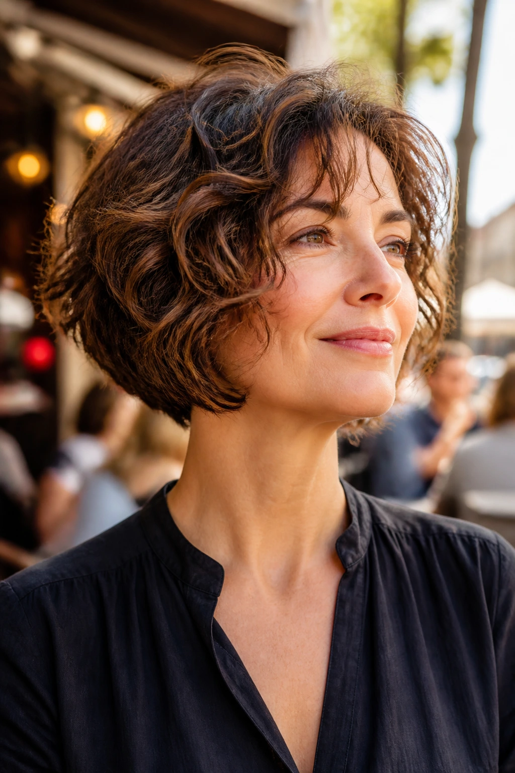 Portrait of a woman with perm-textured stacked bob in natural light
