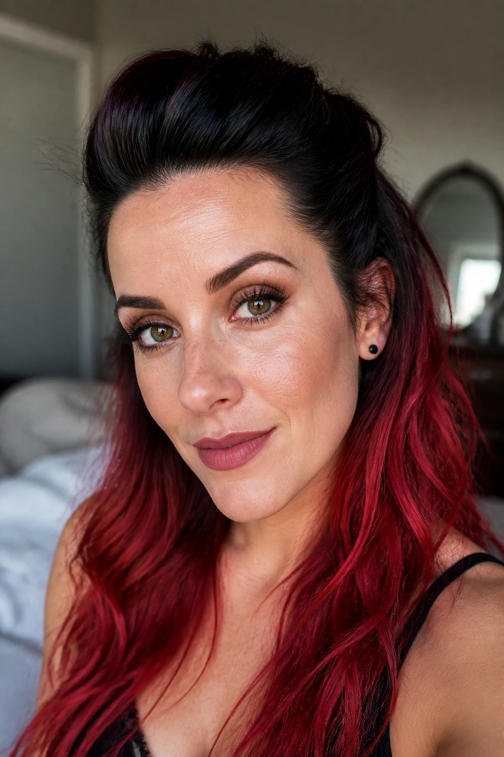 Close-up portrait of a real woman with pinned-back quiff and black-to-red hair, warm morning light