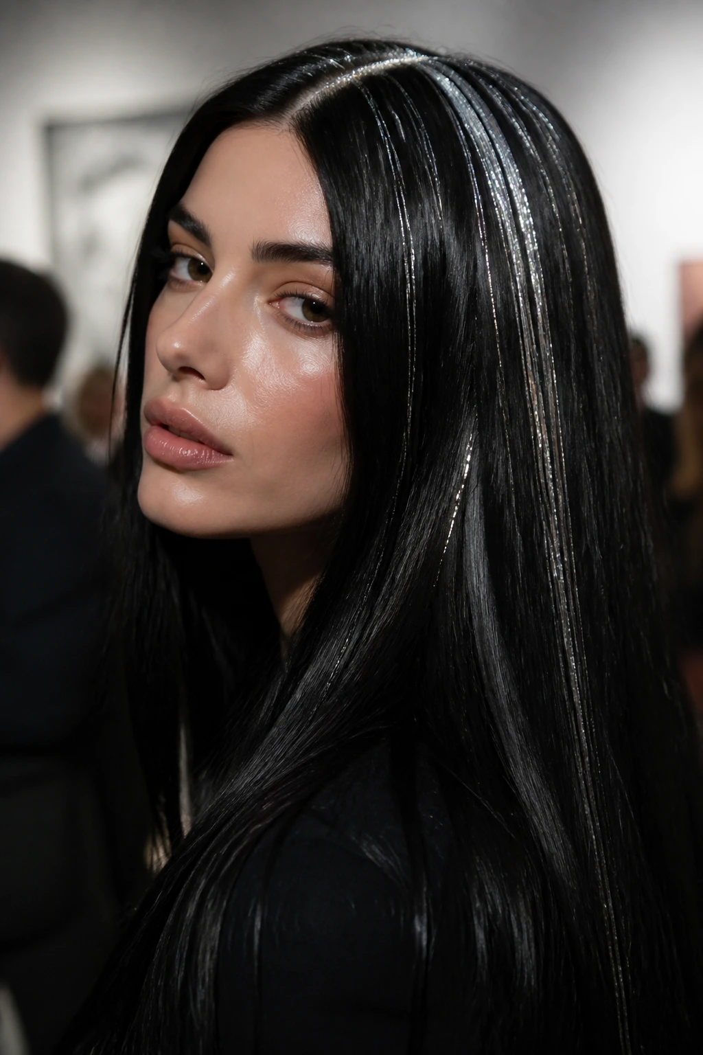 Close-up of jet black hair with platinum tinsel along the part