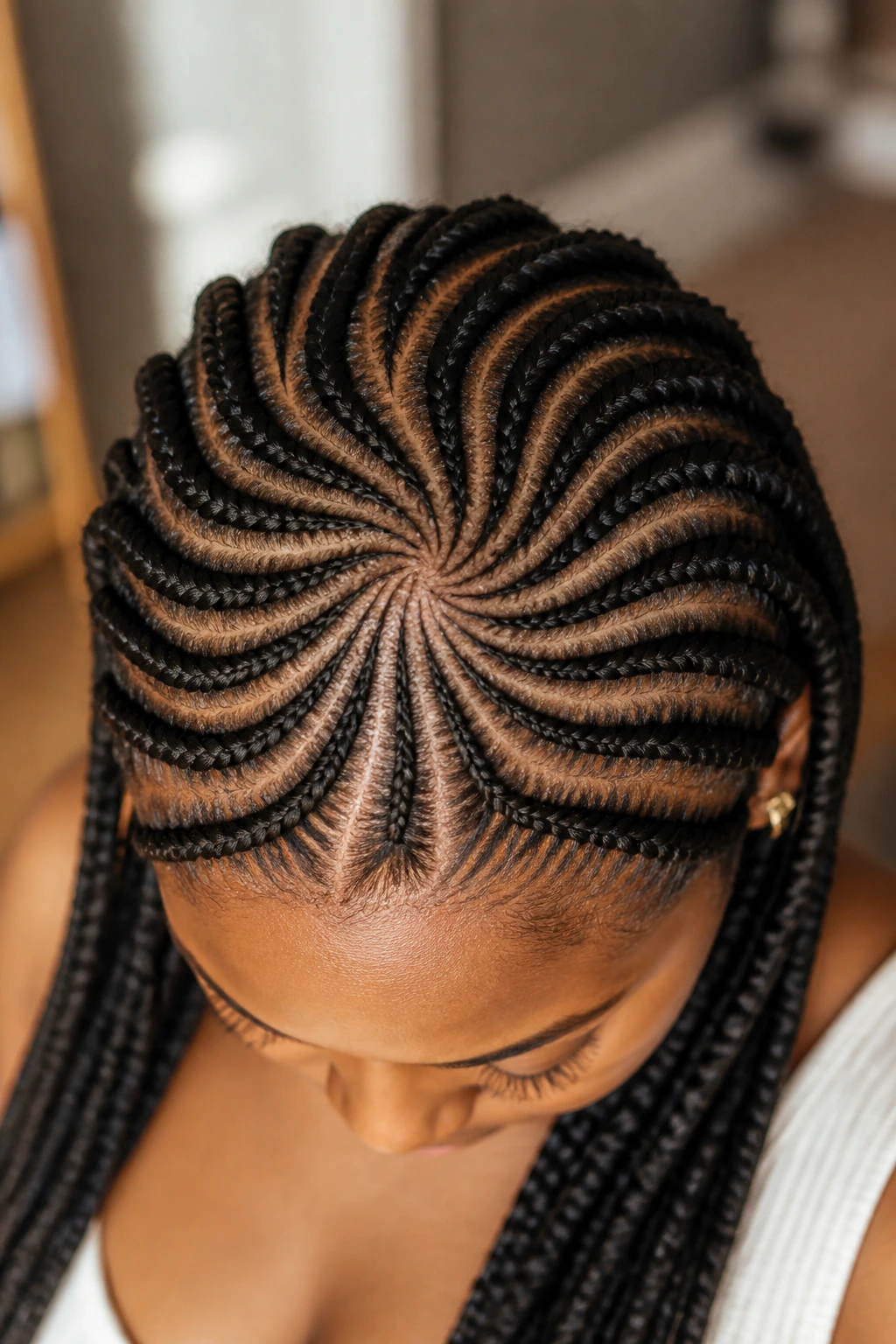Top-down close-up of a real woman with radial swirl Ghana braids