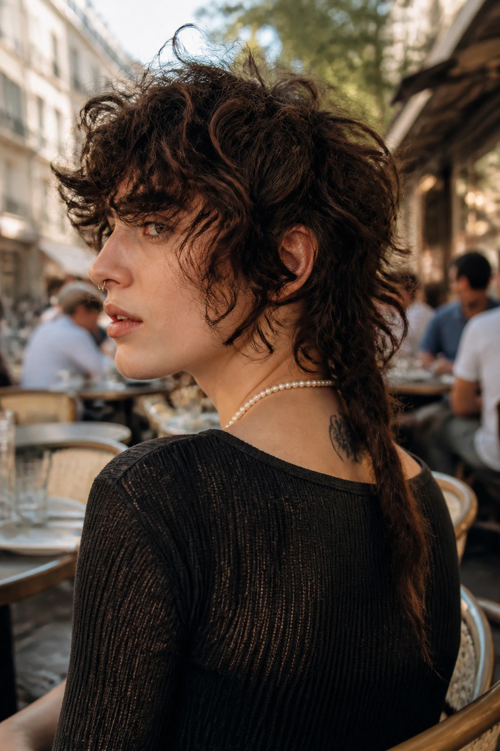Close-up of a real person with a rattail shag hairstyle showing a tail at the nape