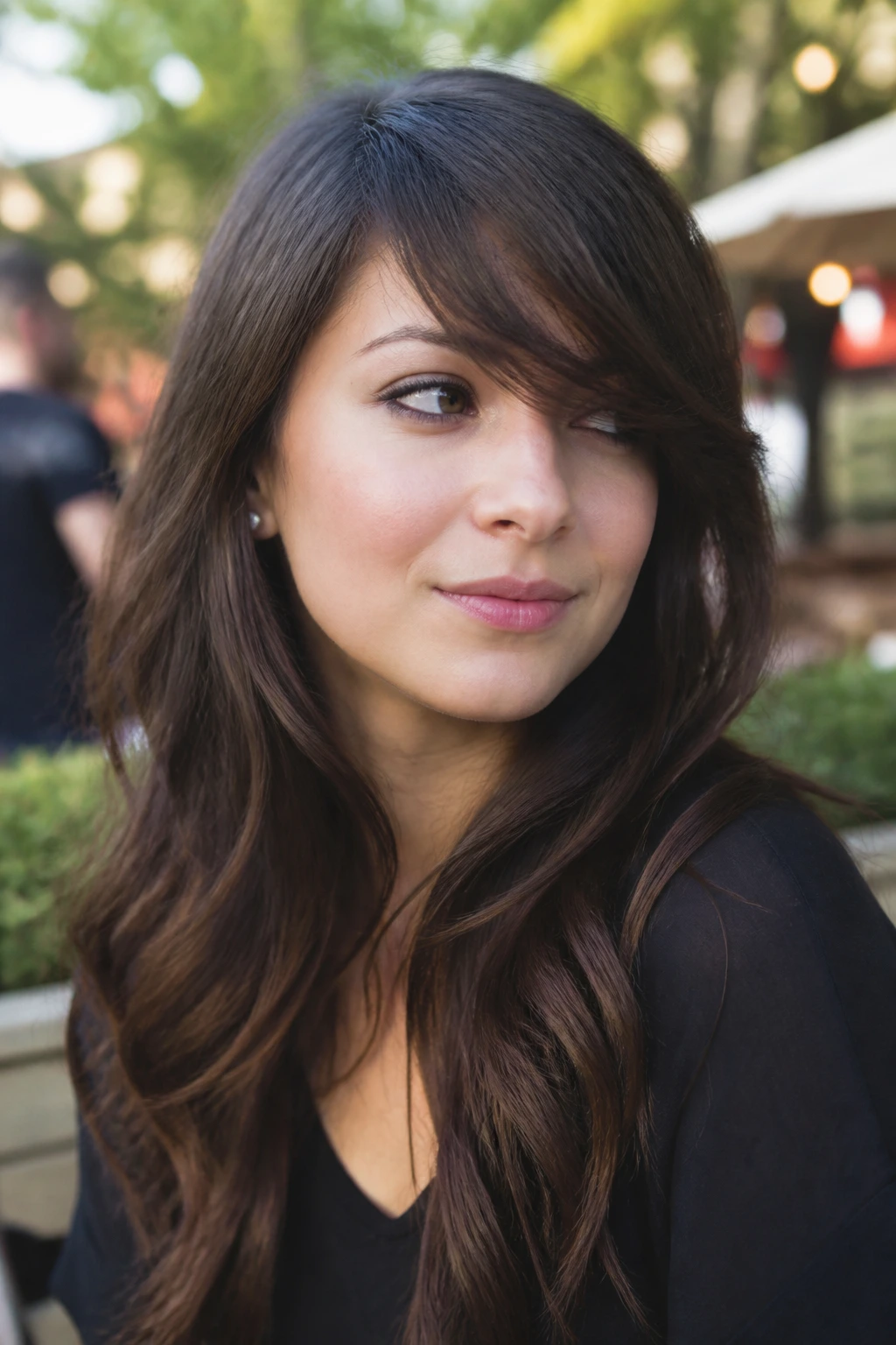 Close-up of a real woman with side-swept asymmetrical bangs and soft waves.