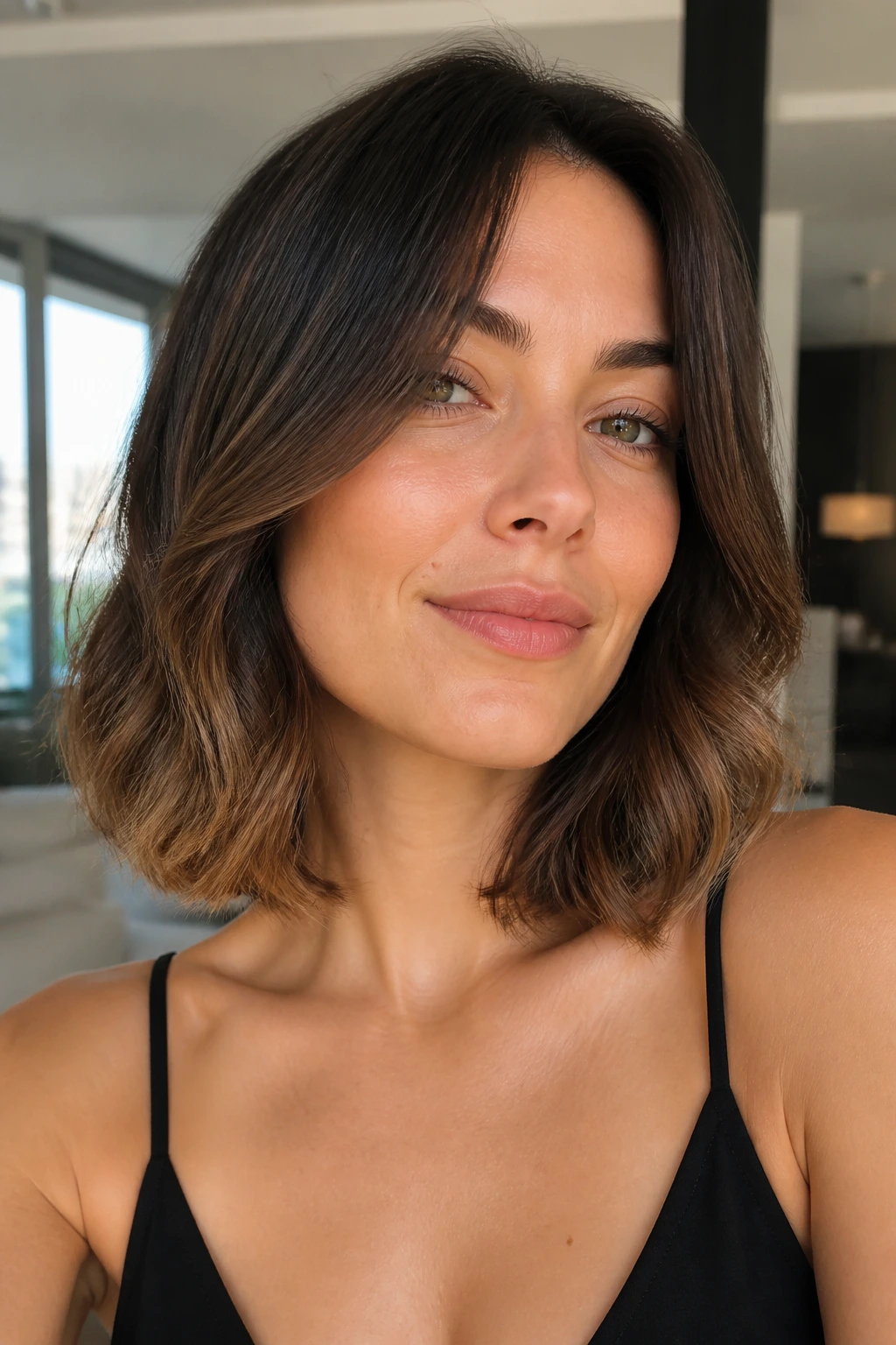 Close-up portrait of a real woman with a sleek top and wavy bottom hair