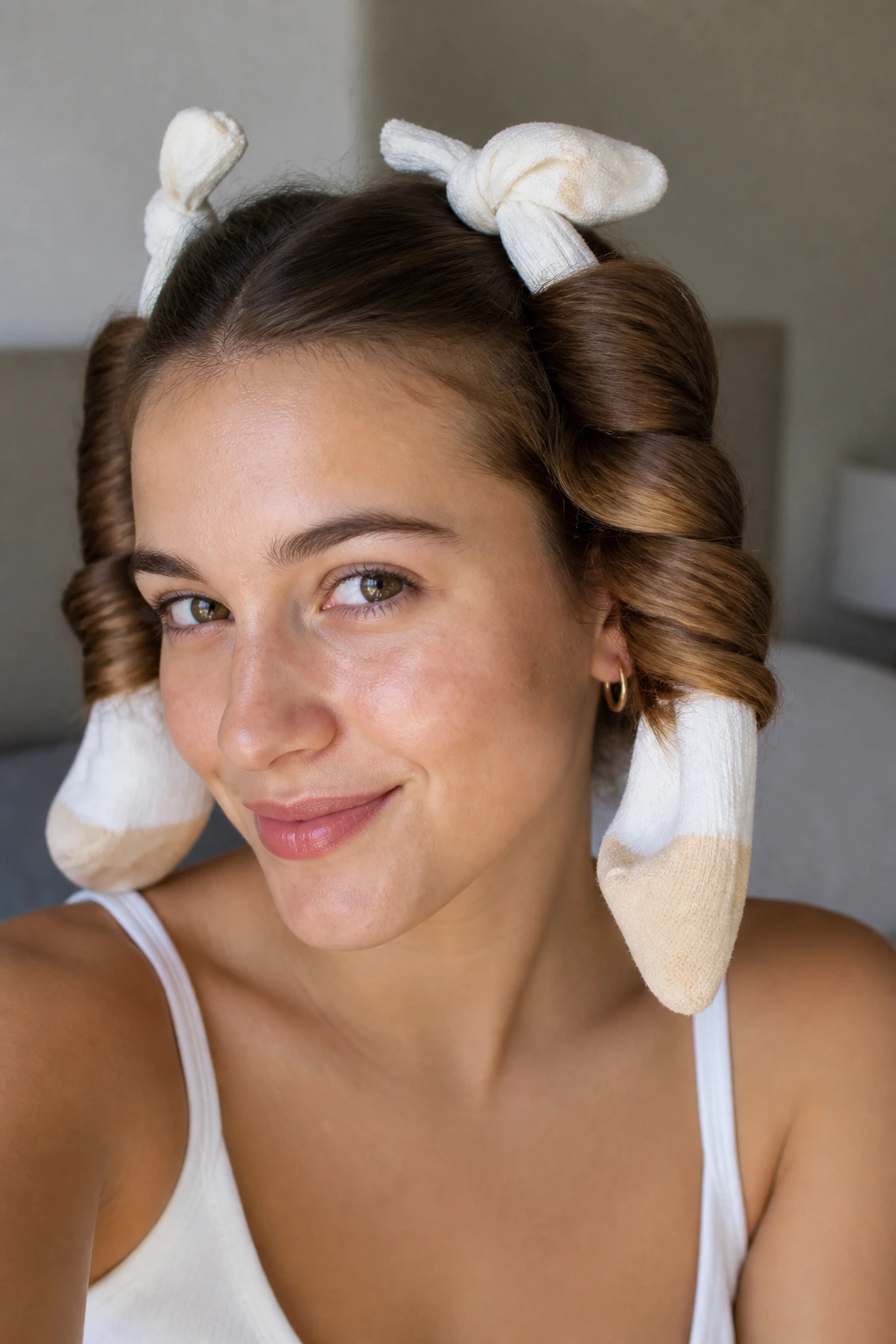 Real woman with hair wrapped around socks forming curls