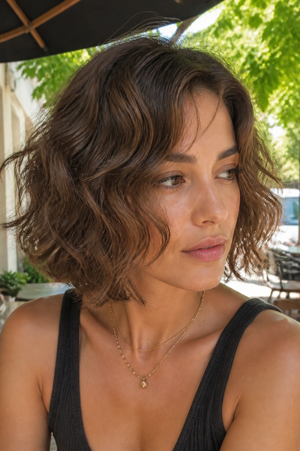 Close-up of a softly permed bob with loose waves outdoors