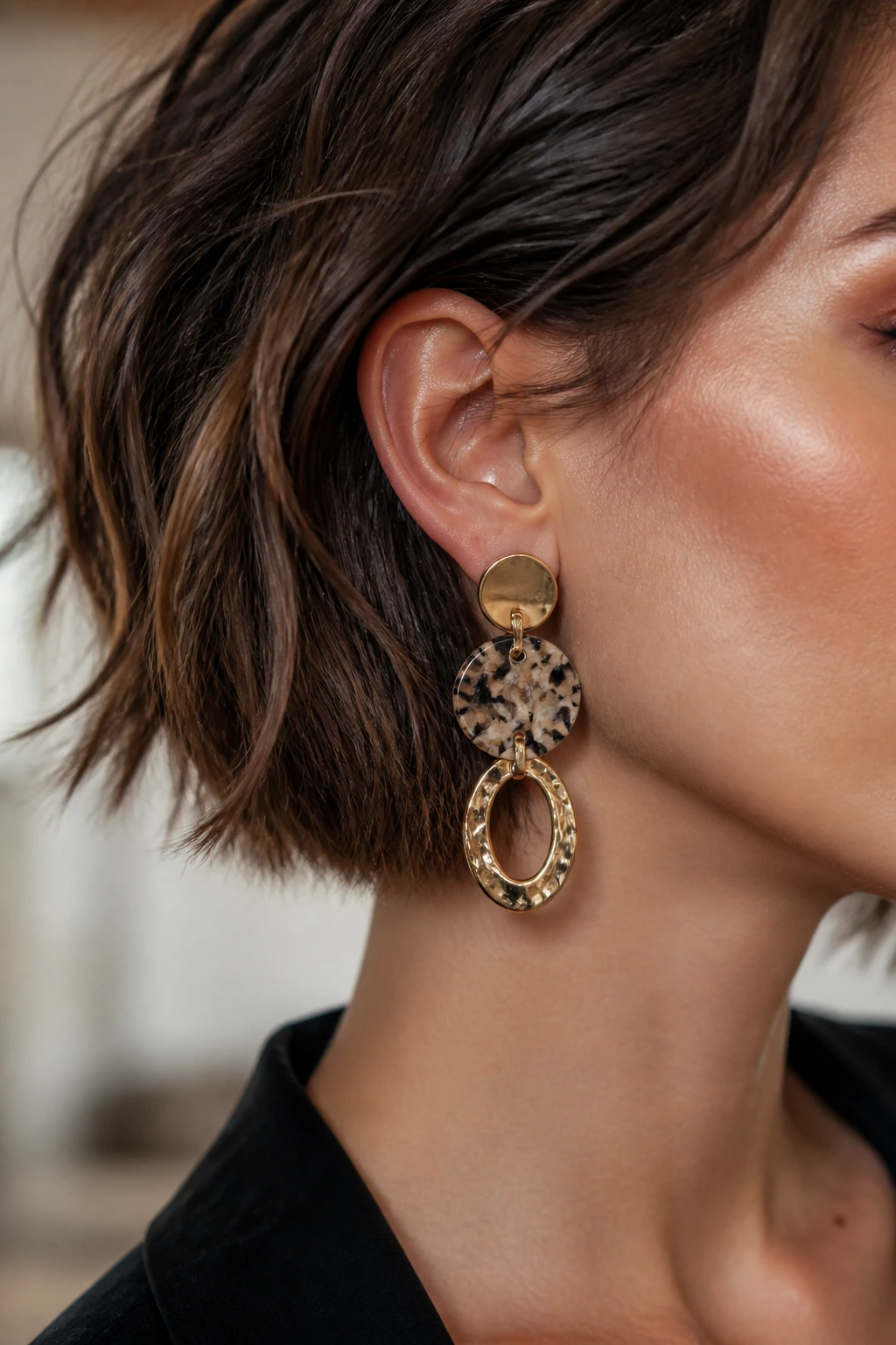 Close-up portrait of a woman wearing bold statement earrings